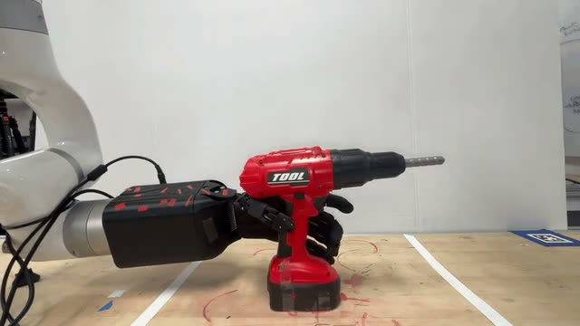 Robot hand lifting a power drill with a VisTacAlign co-trained policy